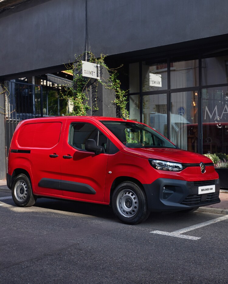 Man charging his red new Berlingo Van