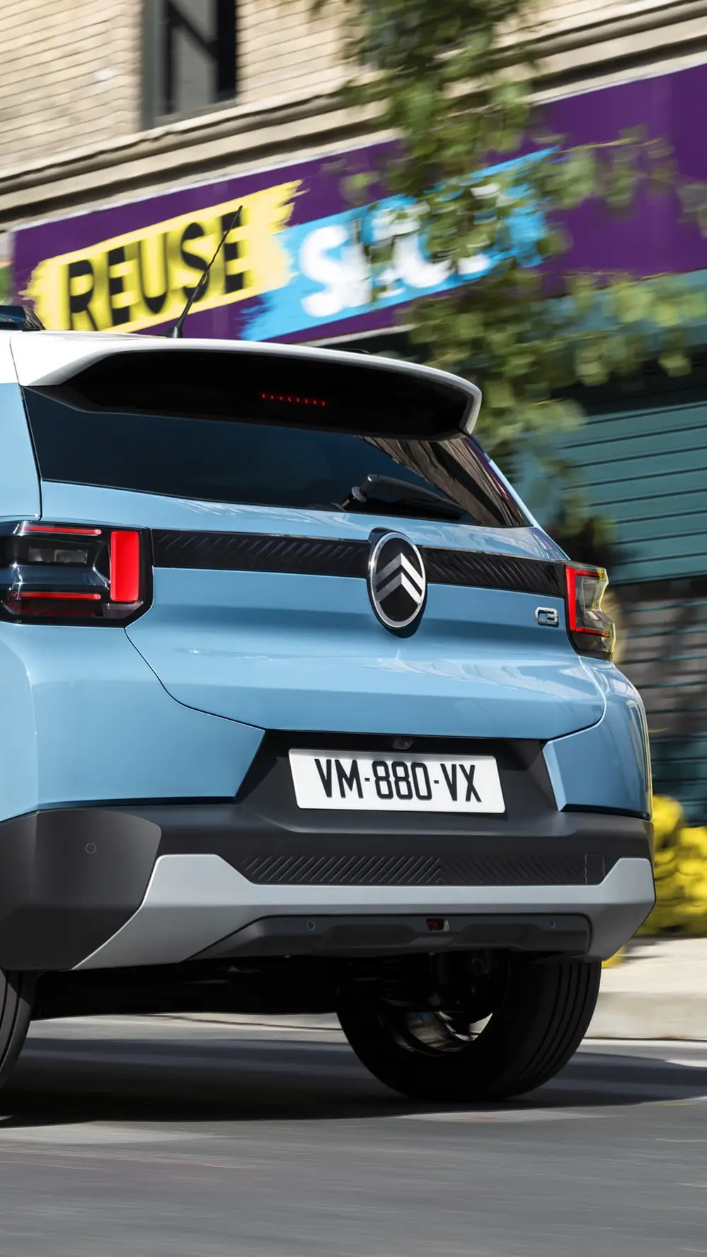 Rear three‑quarter driving view of Citroën C3 compact city car highlighting modern tail‑light design for confident, efficient and affordable mobility.